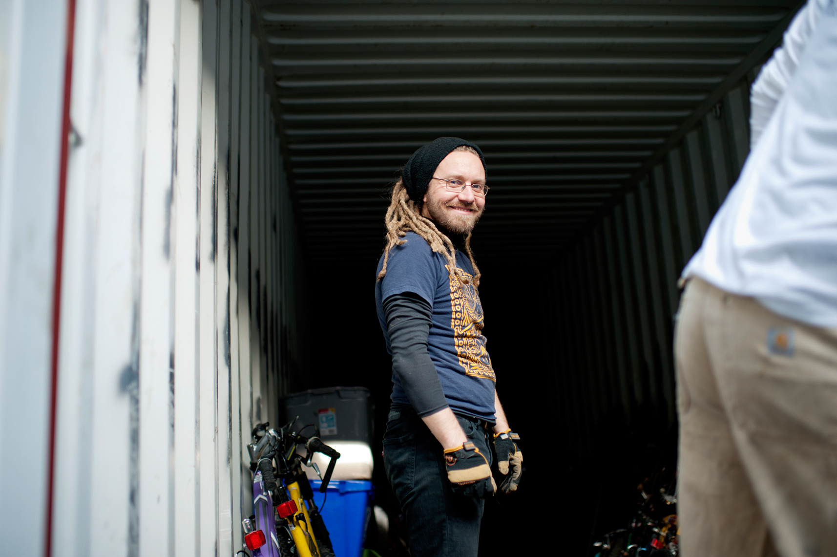 Bikes Not Bombs volunteer packing reclaimed bikes into shipping container to ship to Nicaragua