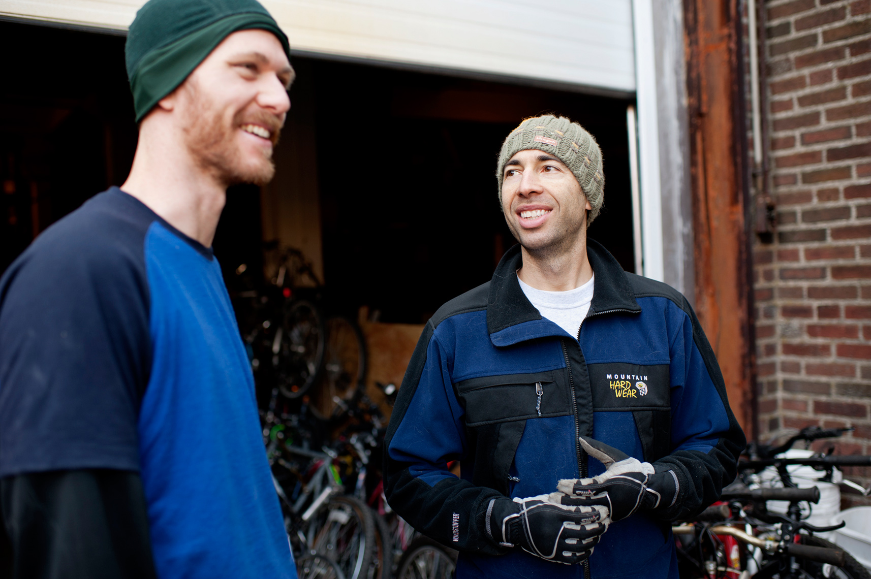 volunteers loading used donated bicycles onto shipping container to ship worldwide for social change
