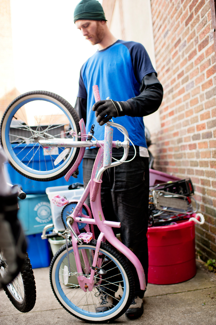 volunteer repairing donated bicycle for Bikes Not Bombs to ship to Guatemala