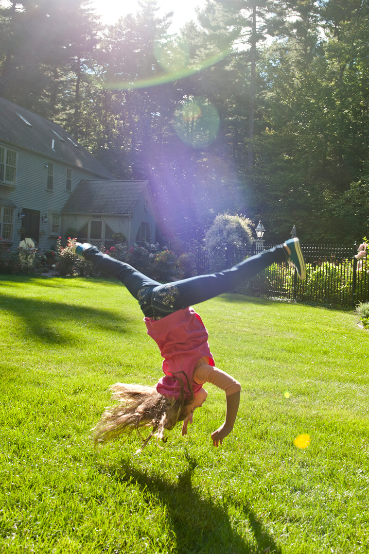 girl doing cartwheel living the rural life in Western Massachusetts for the Boston Globe