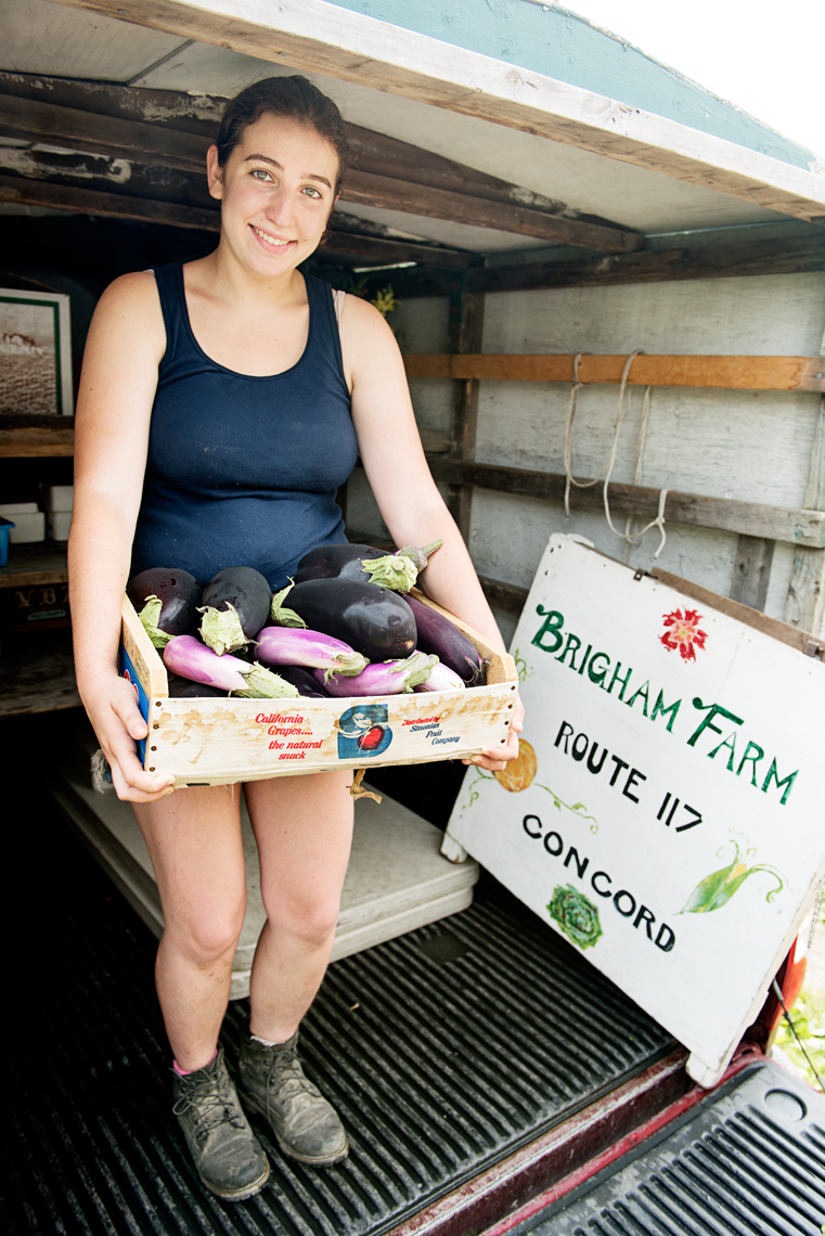 young woman unloading vegetables for Brigham Farm