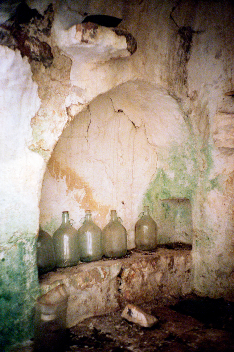 glass wine jugs in trullo traditional Apulia dry stone hut Southern Italy