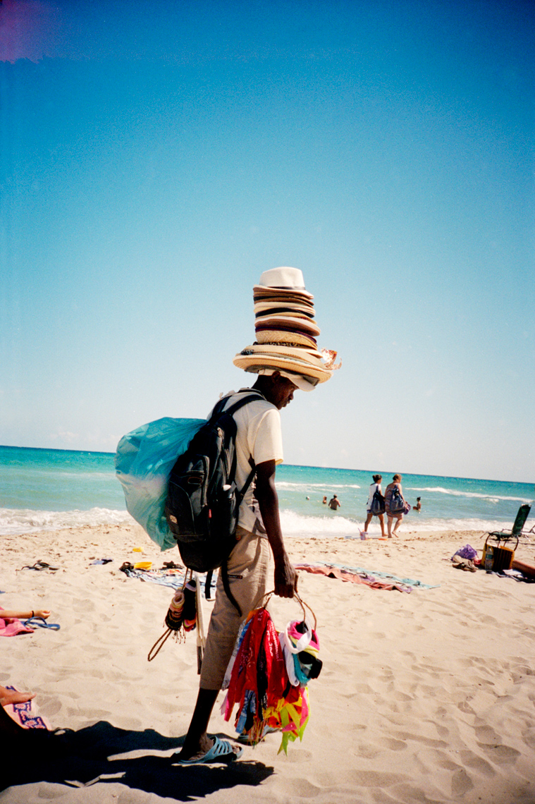 hat vendor on beach Torre Canne Puglia