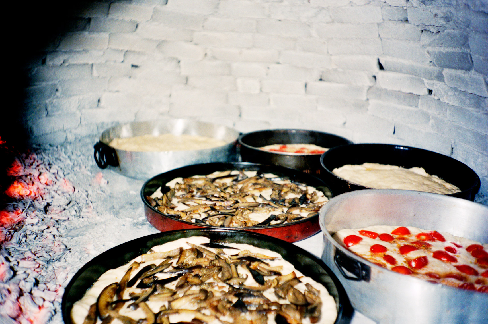 cooking pizza in outdoor oven on in trullo farm 