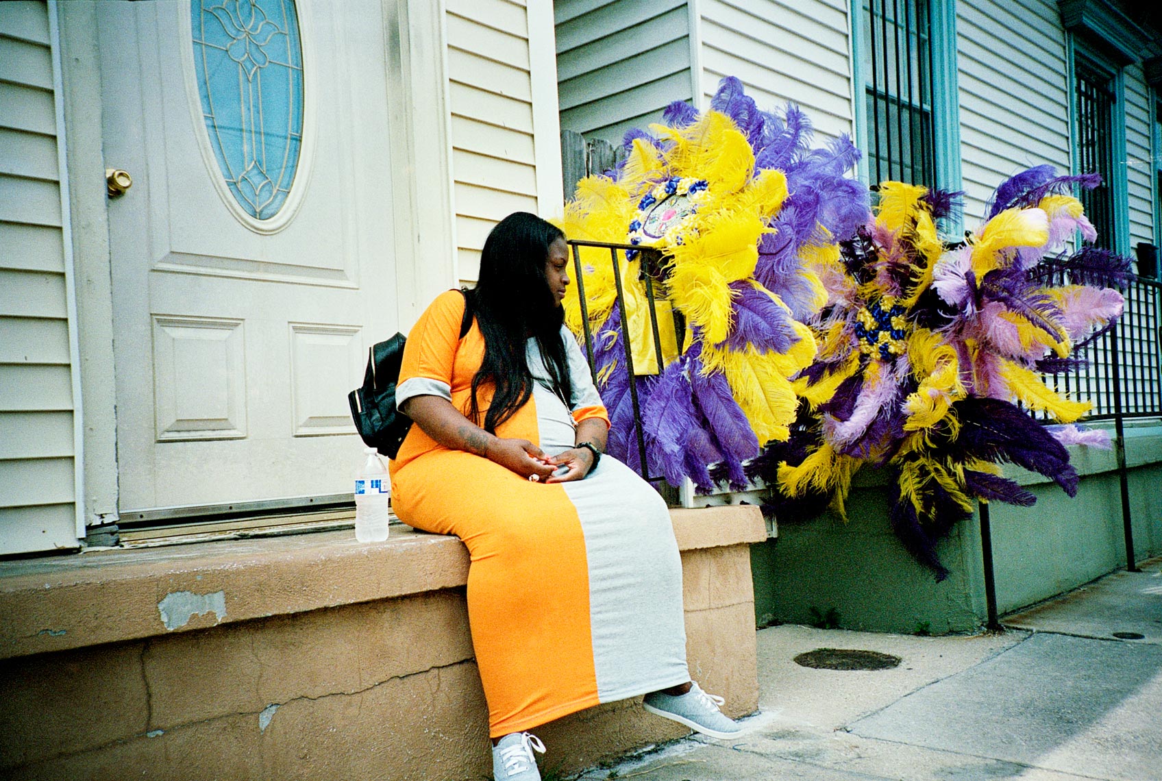 tribe members helping with costume preparation near A.L. Lewis Park for Mardi Gras Indian Parade
